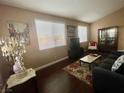 Comfortable living room with hardwood floors, large windows, and stylish decor at 8203 Heather Rock Ct, Las Vegas, NV 89117