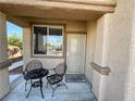 Inviting porch with wrought iron furniture and welcome mat, perfect for relaxing at 8203 Heather Rock Ct, Las Vegas, NV 89117