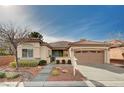 Charming single story home with desert landscaping, covered porch, and attached two car garage at 85 Alerion St, Las Vegas, NV 89138