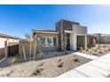 Stylish single-story home with desert landscaping and a stone-accented facade at 889 Elmwood Forest Ln, Las Vegas, NV 89138