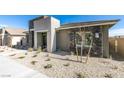 Modern home exterior showcasing stone accents, desert landscaping, and contemporary design at 889 Elmwood Forest Ln, Las Vegas, NV 89138