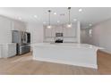 Modern kitchen with light gray cabinets, quartz countertops, and stainless steel appliances at 9062 Lucky Crest St, Las Vegas, NV 89113