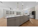 Modern kitchen island with white countertop and gray cabinets at 9062 Lucky Crest St, Las Vegas, NV 89113