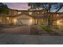 Inviting two-story home with brick driveway, well-manicured lawn, and stylish front door at 1163 Highbury Grove St, Henderson, NV 89002