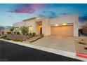 Contemporary home with manicured landscaping and a spacious driveway at 11895 Skyline Arch Ct, Las Vegas, NV 89138