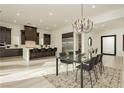 Open-concept kitchen and dining area with stainless steel appliances and modern finishes at 11895 Skyline Arch Ct, Las Vegas, NV 89138