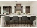 Modern kitchen featuring a large island, stylish seating and ample storage at 11895 Skyline Arch Ct, Las Vegas, NV 89138