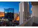 Balcony view with a vibrant cityscape featuring modern high-rise buildings on a clear day at 135 E Harmon Ave # 2601&2603, Las Vegas, NV 89109