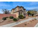 Spacious two-story house featuring a terra-cotta colored privacy wall and drought resistant landscaping at 1381 Robard St, Las Vegas, NV 89135