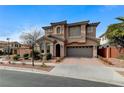 Attractive two-story home with stucco exterior, tile roof, an attached garage, and desert landscaping at 1381 Robard St, Las Vegas, NV 89135