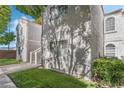 Townhouse with a stucco exterior, manicured grass, sidewalks and shade trees at 1800 Edmond St # 108, Las Vegas, NV 89146