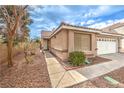 Inviting front entrance with a walkway, desert landscaping, and a two-car garage at 2153 Hookcross Cir, Henderson, NV 89074