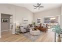 Bright living room featuring vaulted ceilings, stylish furnishings, and sliding glass doors to the backyard at 2401 Rockford St, Las Vegas, NV 89134