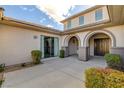 A covered walkway leads to the front door, accentuated by beautiful landscaping and architectural details at 3 Chenal Pass, Henderson, NV 89052