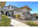 A covered walkway leads to the front door, accentuated by beautiful landscaping and architectural details at 3 Chenal Pass, Henderson, NV 89052