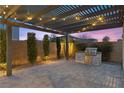 Outdoor kitchen with built-in grill and pergola covered patio perfect for entertaining at 3025 Merlesco Ave, Henderson, NV 89044