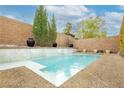 Inviting backyard pool with water feature, complemented by stylish tile and privacy wall at 3163 Biccari Ave, Henderson, NV 89044