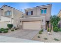 Inviting two-story home with a neutral palette, featuring a two-car garage and low-maintenance desert landscaping at 387 Layla Bay St, Henderson, NV 89014