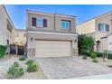 Charming two-story home featuring a well-maintained exterior, desert landscaping, and a convenient two-car garage at 387 Layla Bay St, Henderson, NV 89014