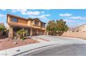 Inviting two-story home boasts a red tile roof, desert landscaping, and a spacious three-car garage at 4133 Perfect Lure St, Las Vegas, NV 89129