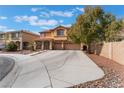 Inviting two-story home boasts a red tile roof, desert landscaping, and a spacious three-car garage at 4133 Perfect Lure St, Las Vegas, NV 89129