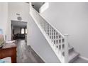 Bright entryway features a staircase with white railing, neutral walls, and wood-look tile flooring at 4220 Porticella Ave, North Las Vegas, NV 89084