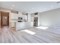 Open-concept kitchen featuring white cabinets, stainless steel appliances, and a large center island at 4341 Sunburst Spring Ave, Las Vegas, NV 89141