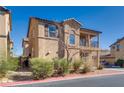 Exterior angle of a tan two-story home featuring a second-story balcony and desert landscaping at 4626 Lime Straight Dr, Las Vegas, NV 89115