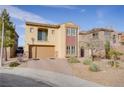 Charming two-story home featuring desert landscaping and a brick paved driveway at 500 Via Stretto Ave, Henderson, NV 89011