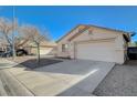 Front view of a house with a driveway and desert landscaping at 5205 Mantua Ct, Las Vegas, NV 89130