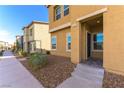 Street view of a modern home with tan stucco, well-maintained landscaping and sidewalk at 546 Foothill Cove Ln, Henderson, NV 89002