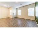 Bright, open-concept living room with stylish laminate floors, ample natural light from multiple windows and fresh paint at 546 Foothill Cove Ln, Henderson, NV 89002