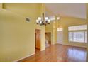 Bright living room with wood floors, chandelier, and stairs to the second floor at 6086 Shadow Oak Dr, North Las Vegas, NV 89031