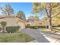 Charming single-story home with a well-manicured lawn and a two-car garage at 6961 Emerald Springs Ln, Las Vegas, NV 89113