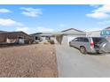 Charming single-story home with a low-maintenance rock yard and a two-car garage on a sunny day at 720 Sam Jonas Dr, Las Vegas, NV 89145