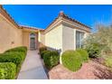 Front entrance with walkway and lush green shrubs at 7232 Vista Bonita Dr, Las Vegas, NV 89149