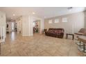 Expansive living room with tile flooring, recessed lighting, and neutral color palette at 7321 Aspire Ct, Las Vegas, NV 89113