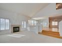 Bright living room featuring hardwood floors, a fireplace, and high ceilings at 7337 Tealwood St, Las Vegas, NV 89131