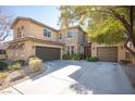 Two-story house with stone accents and a three-car garage at 7435 Sun Summit Ct, Las Vegas, NV 89178