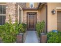 Ornate front door with decorative iron gate and landscaping at 7435 Sun Summit Ct, Las Vegas, NV 89178