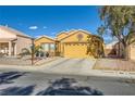 Front yard view of a one-story house with a yellow garage at 7666 Rainbow Cove Dr, Las Vegas, NV 89131