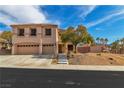 Inviting two-story home featuring a three-car garage and landscaped front yard under a blue sky at 790 Tossa De Mar Ave, Henderson, NV 89002