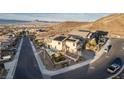 Expansive aerial view of a home featuring a pool, solar panels, and mountain views at 864 Firestone Ledge Ave, Henderson, NV 89012