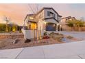 Beautifully landscaped front yard and modern home exterior at dusk at 864 Firestone Ledge Ave, Henderson, NV 89012