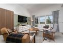 Modern living room featuring stylish furnishings, a sleek entertainment center, and large windows for ample natural light at 91 Alta Cascata Pl, Henderson, NV 89011