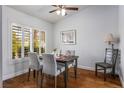 Inviting dining room with hardwood floors, a ceiling fan, and bright natural light at 9300 Villa Ridge Dr, Las Vegas, NV 89134