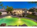 Aerial view of a house with a backyard, pool, patio, and lush landscaping at 10528 Meadow Mist Ave, Las Vegas, NV 89135