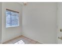 This bedroom features tile flooring, a window, and neutral walls at 107 Topsail Dr, Boulder City, NV 89005