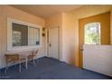 This patio features neutral walls, two windows, and a table with two chairs at 107 Topsail Dr, Boulder City, NV 89005