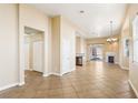 Spacious open-concept living area featuring tile flooring, a fireplace, and ample natural light at 10765 Muscari Way, Las Vegas, NV 89141